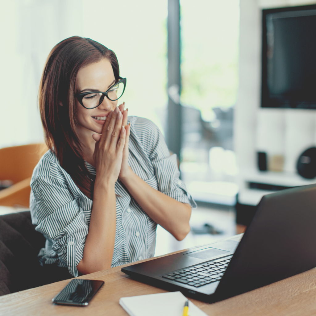 Business owner looking at good news from a laptop.